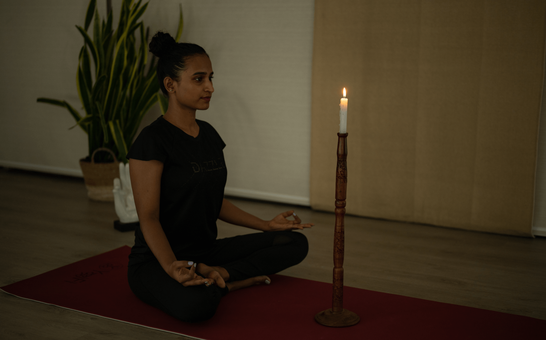 Elegant tratka stand holding a lit candle, creating a warm ambiance.